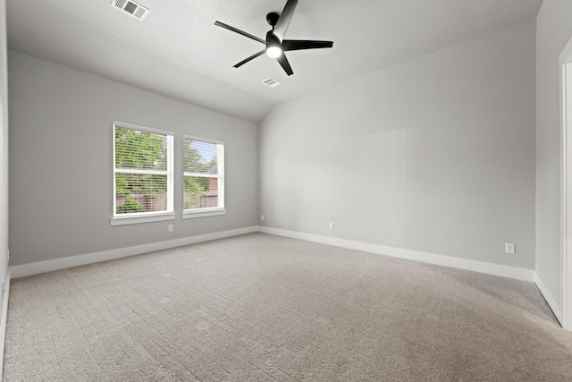 carpeted empty room featuring vaulted ceiling and ceiling fan