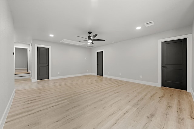 spare room with ceiling fan and light wood-type flooring