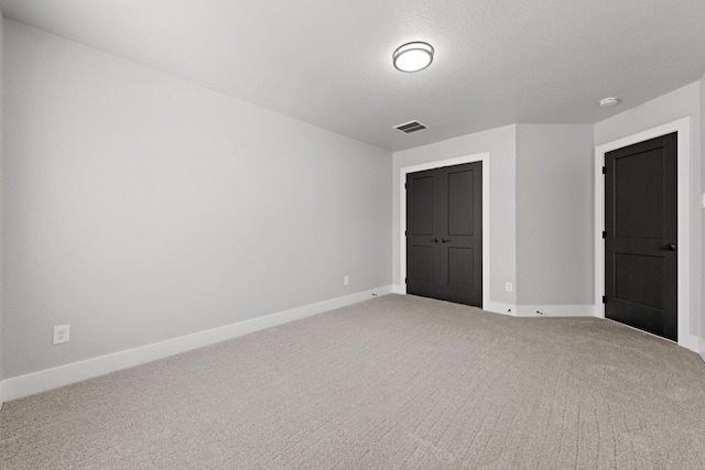 unfurnished bedroom with carpet and a closet