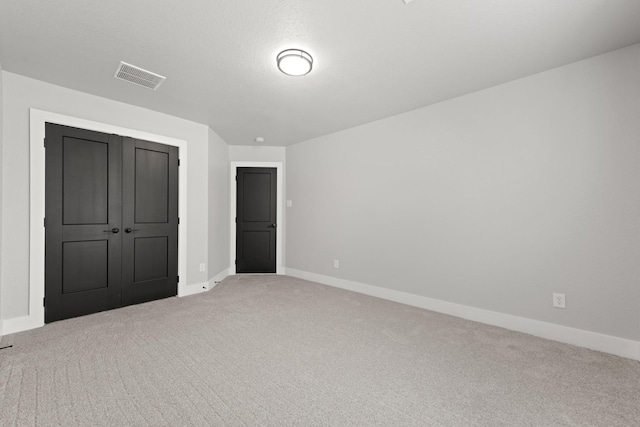 unfurnished bedroom with carpet and a closet