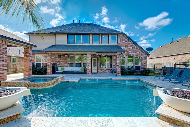 view of pool with pool water feature, a patio, an in ground hot tub, and an outdoor living space