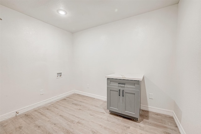 laundry room featuring light hardwood / wood-style flooring and washer hookup