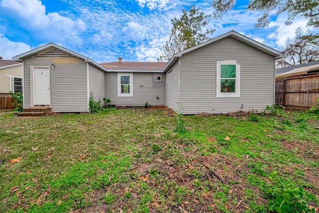 rear view of house with a yard