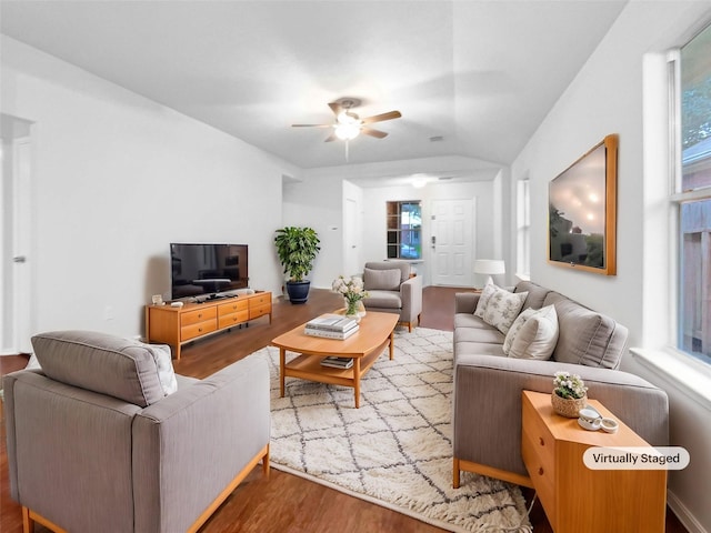 living room with ceiling fan, wood-type flooring, and lofted ceiling