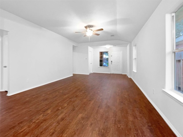 unfurnished living room with dark hardwood / wood-style flooring, vaulted ceiling, and ceiling fan