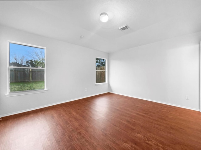 unfurnished room with dark hardwood / wood-style flooring