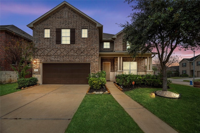 view of property with a lawn and a garage