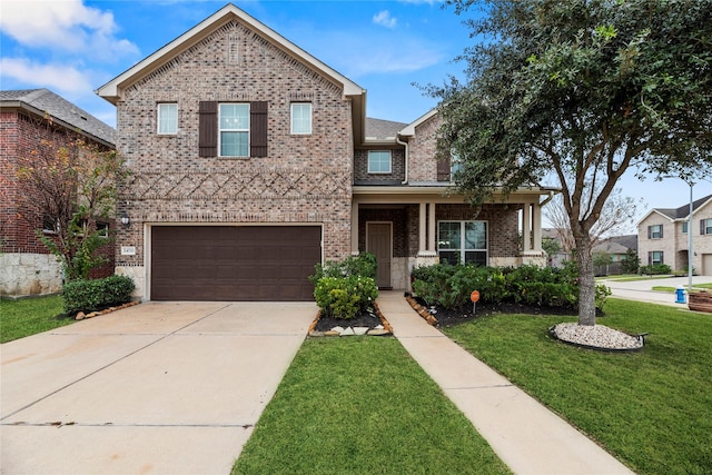 view of front of property featuring a front yard and a garage