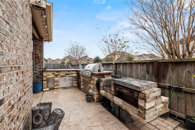 view of patio / terrace with area for grilling and a grill