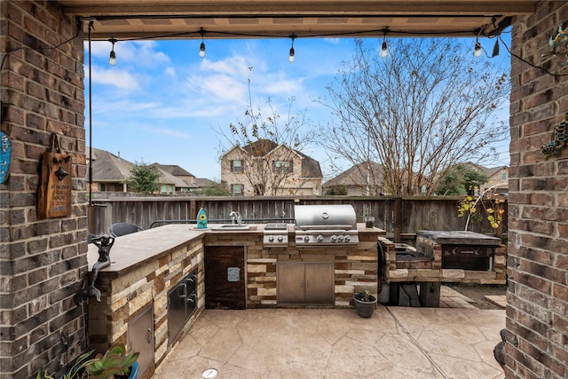 view of patio / terrace with grilling area and an outdoor kitchen