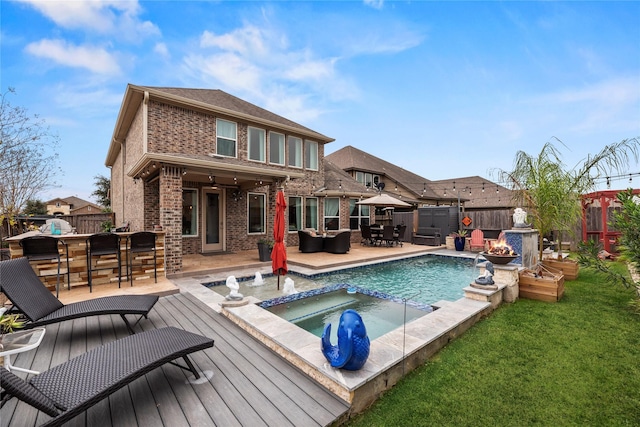 rear view of property with exterior bar and a pool with hot tub