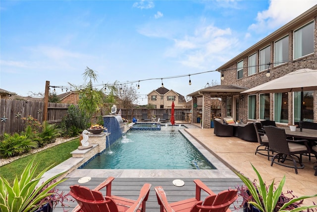 view of pool with a patio area, an in ground hot tub, and pool water feature