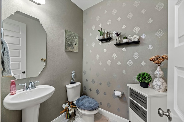 bathroom featuring tile patterned floors, toilet, and sink