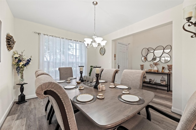 dining space with a chandelier and light hardwood / wood-style flooring