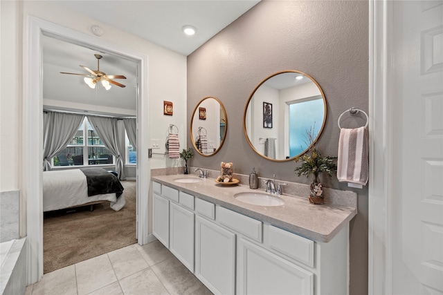 bathroom with tile patterned floors, vanity, and ceiling fan