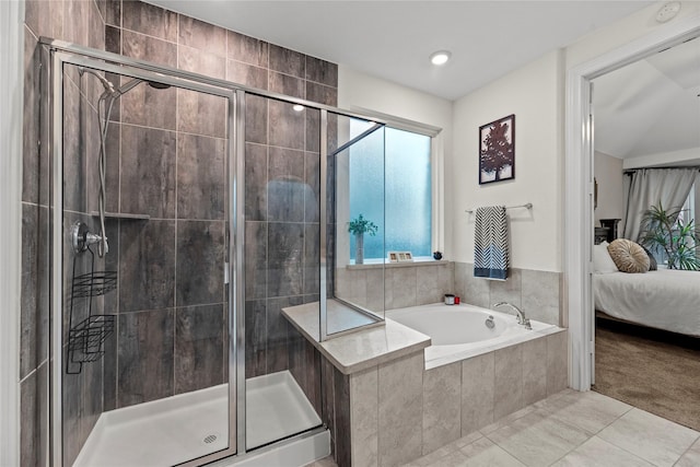 bathroom featuring tile patterned floors and independent shower and bath