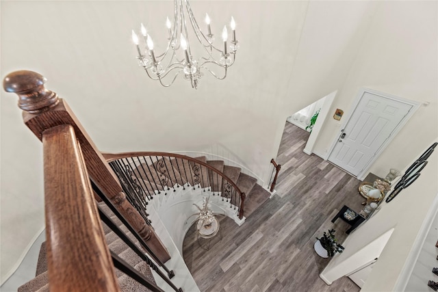 stairs with a chandelier and wood-type flooring