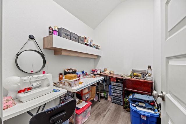 home office featuring light hardwood / wood-style flooring and vaulted ceiling