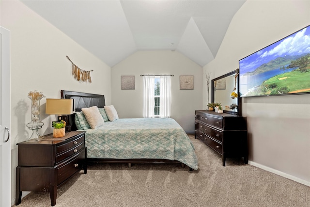 bedroom featuring light colored carpet and vaulted ceiling