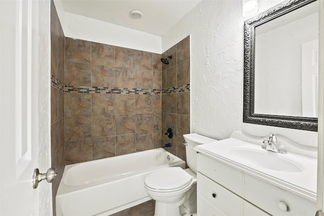 full bathroom with toilet, vanity, and tiled shower / bath