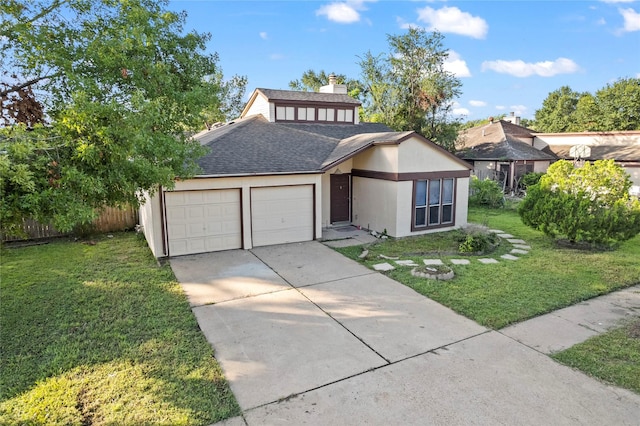 view of front of home with a front yard and a garage