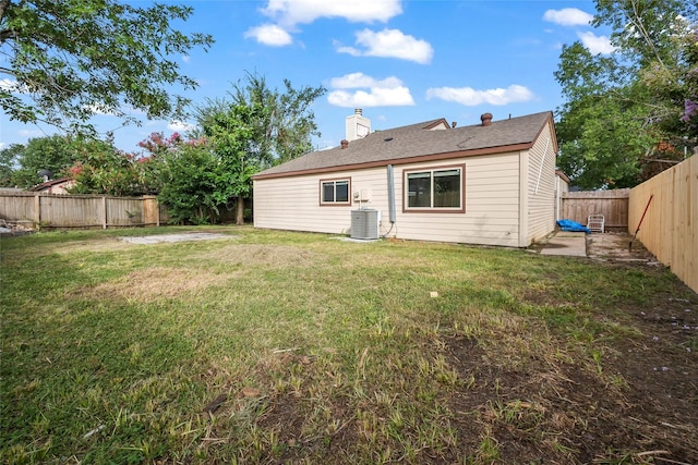 back of property with a yard and cooling unit