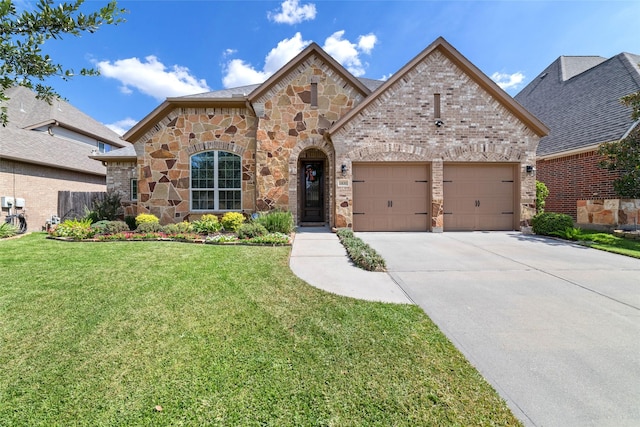 view of front of house featuring a garage and a front yard