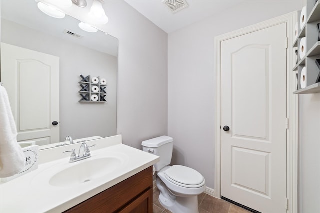 bathroom with vanity, tile patterned floors, and toilet