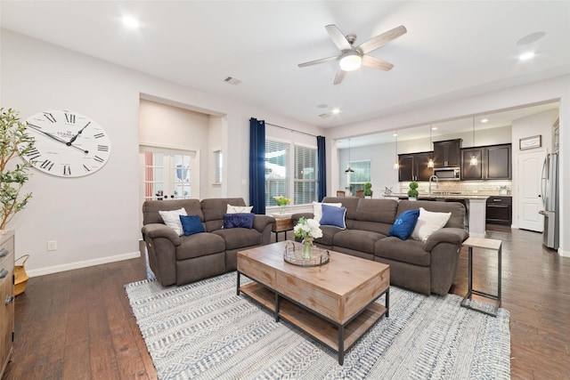 living room featuring wood-type flooring and ceiling fan