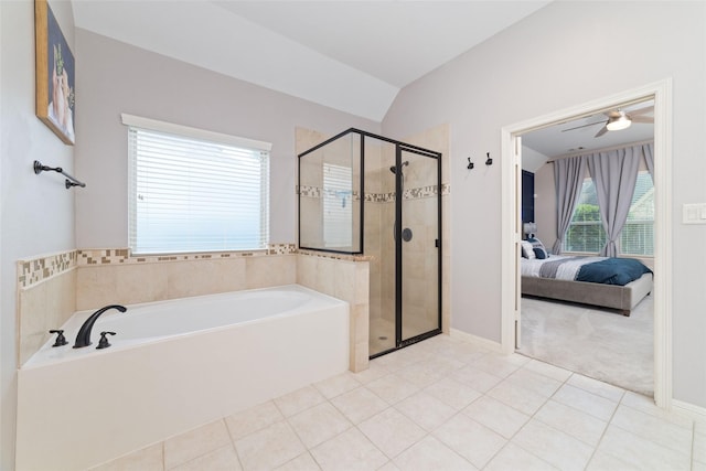 bathroom featuring tile patterned flooring, vaulted ceiling, shower with separate bathtub, and ceiling fan