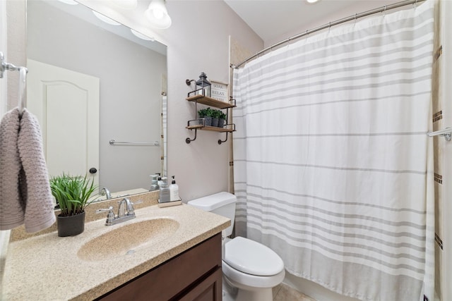 bathroom with vanity, curtained shower, and toilet