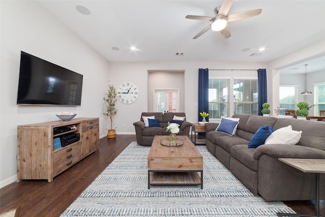 living room with ceiling fan and dark hardwood / wood-style flooring