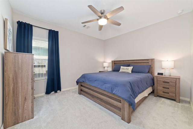 bedroom with ceiling fan and light carpet