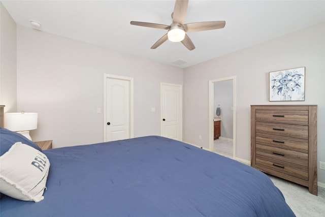 carpeted bedroom featuring connected bathroom and ceiling fan