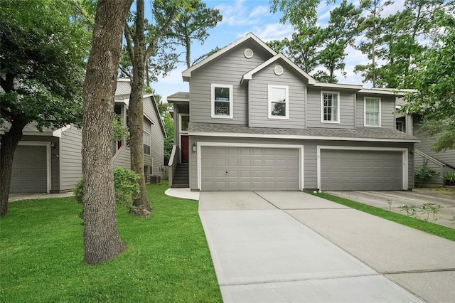 view of front of home with a garage and a front lawn