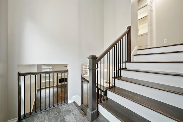 staircase with wood-type flooring