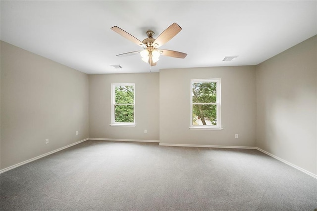 unfurnished room featuring ceiling fan and carpet floors