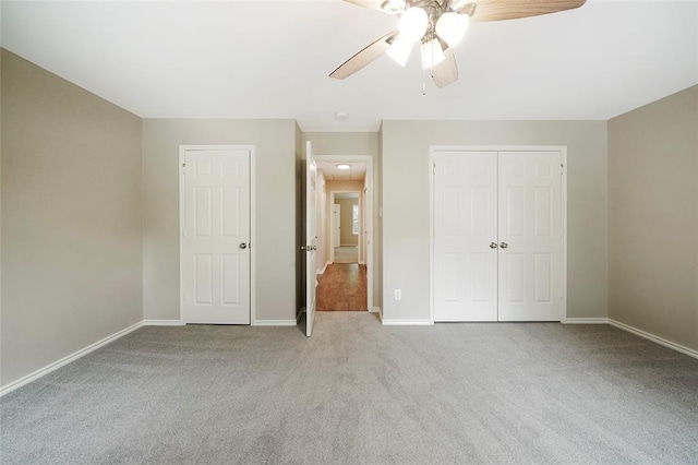 unfurnished bedroom featuring ceiling fan and light carpet