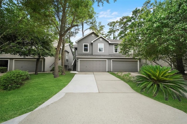 view of front of property featuring a front yard and a garage