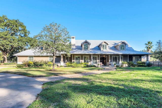 view of front facade with covered porch and a front yard