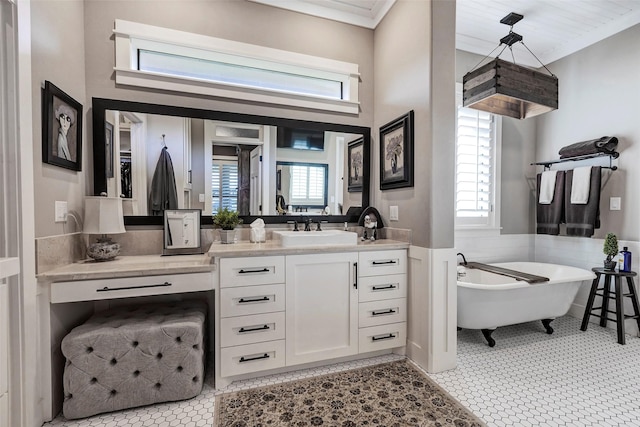 bathroom featuring vanity, a bath, and ornamental molding