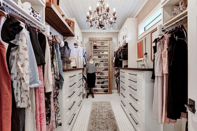 spacious closet featuring a chandelier