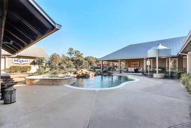 view of swimming pool with an in ground hot tub and a patio