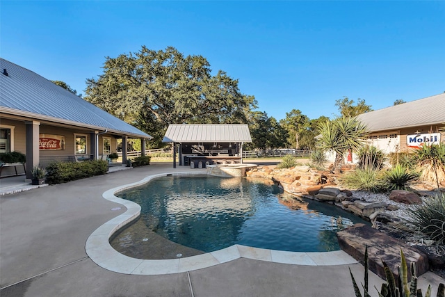 view of pool with a patio area and an outdoor bar