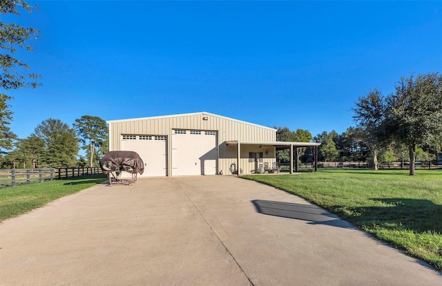 view of front facade featuring a garage, an outdoor structure, and a front lawn