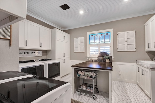 washroom featuring washer and dryer, sink, cabinets, crown molding, and wooden ceiling