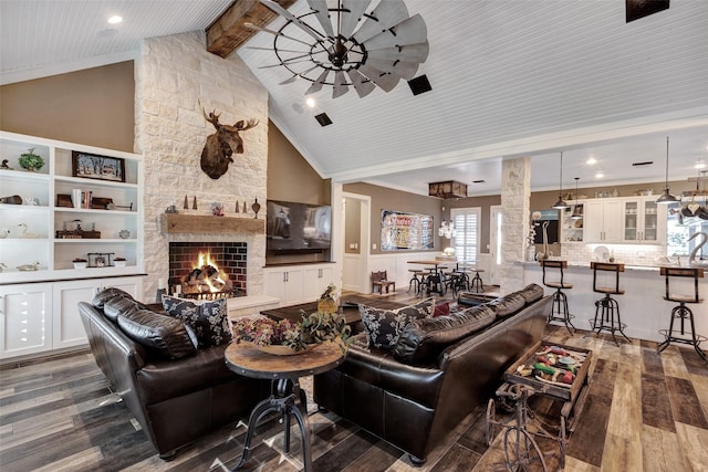 living room with wood ceiling, dark hardwood / wood-style floors, a stone fireplace, and vaulted ceiling with beams