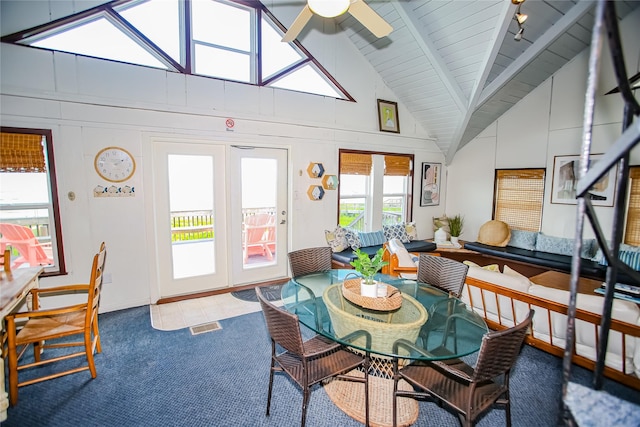 sunroom / solarium with lofted ceiling with beams, ceiling fan, and wooden ceiling