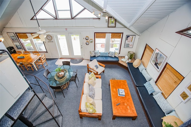 living room with ceiling fan, beam ceiling, carpet floors, and high vaulted ceiling