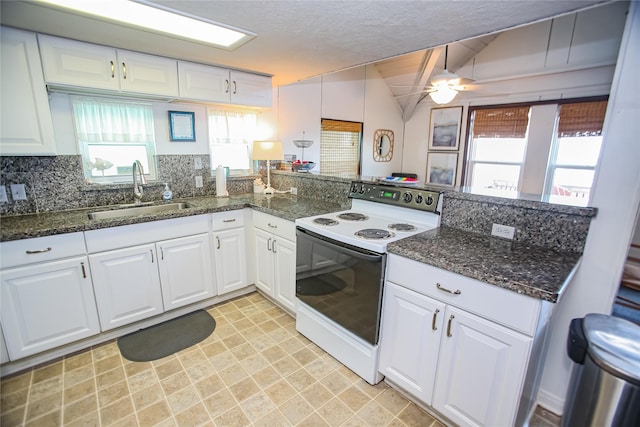 103 Southwind Dr, Surfside Beach, TX 77541 - kitchen featuring white electric range, white cabinetry, ceiling fan, a peninsula, and vaulted ceiling